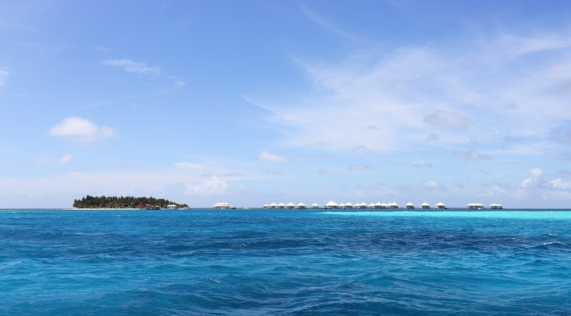 Overwater villas above a turquoise Maldives lagoon