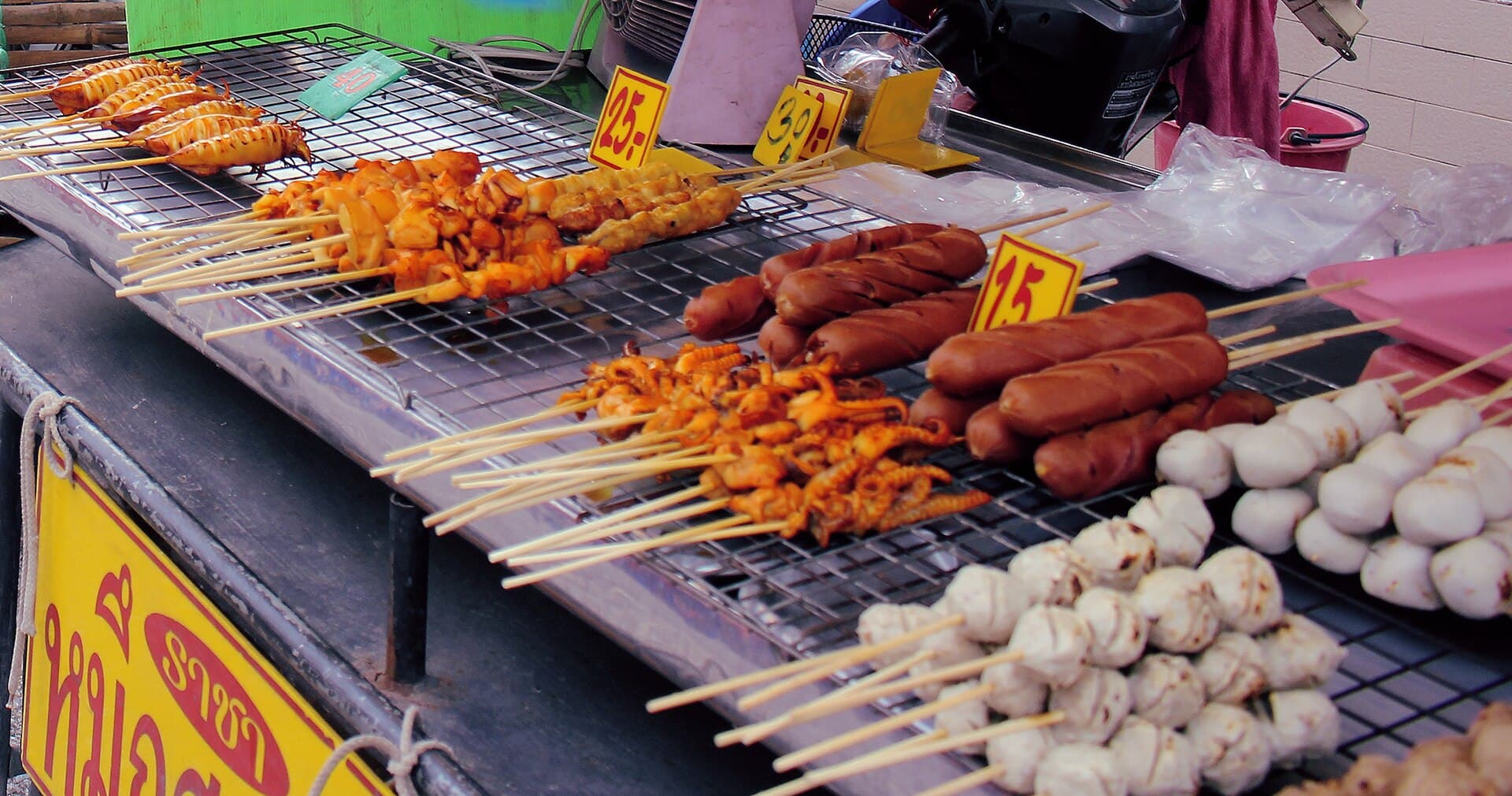 Grilled street-food skewers at a Bangkok market stall